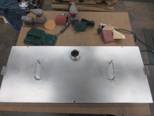 An overhead view of a stainless steel cover ready to be assembled