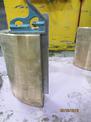 A side view shows a a ruler held against a container after it has been split forged using waterjet technology