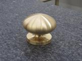 A up-close view of a machined brass mushroom knob