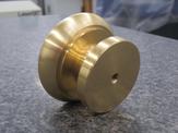 A side view of a machined brass mushroom knob
