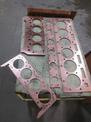 An overhead view of copper head gaskets on top of a moving cart