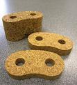 Three pieces of cork that have been waterjet cut