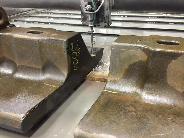 A close up view of a waterjet cutting machined use for cut forging