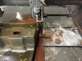 A close up view of a waterjet cutting machine in action