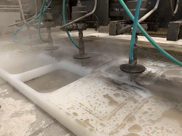 Waterjet cutting 2 inch thick Propylene homopolymer from plate material. Quad heads used on this project to maximize process capabilities with multiple heads.