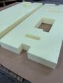 Custom cut foam boards used in an Industrial packaging solution with a corrugated box