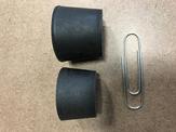 Two rubber stoppers sit beside a paper clip