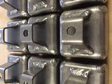 An up close view of multiple 16GA carbon steel mounting brackets