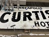 Large porcelain sign with waterjet cut holes for neon tubes