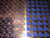 An overhead view of copper parts ready to be cut out