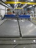 Two massive aluminum plates lie on top of FedTech's machine beds waiting to be cut