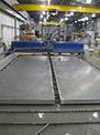 Two massive aluminum plates lie on top of FedTech's machine beds waiting to be cut